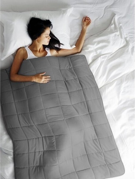 Person sleeps under a weighted blanket