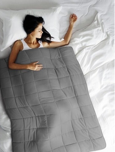 Person sleeps under a weighted blanket