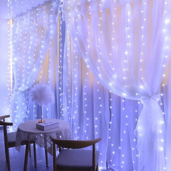 Fairy lights drape down a wall