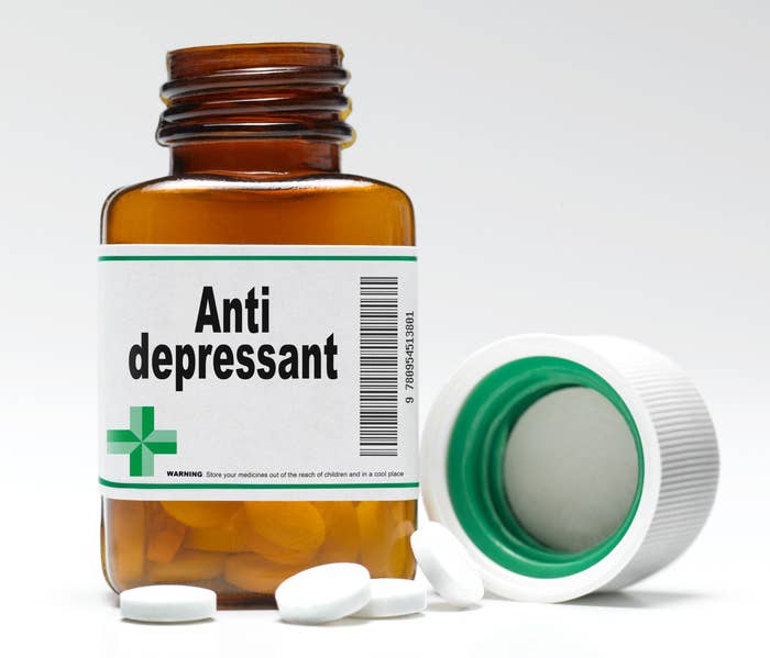An open bottle of pills that is labeled &quot;Anti depressant&quot;
