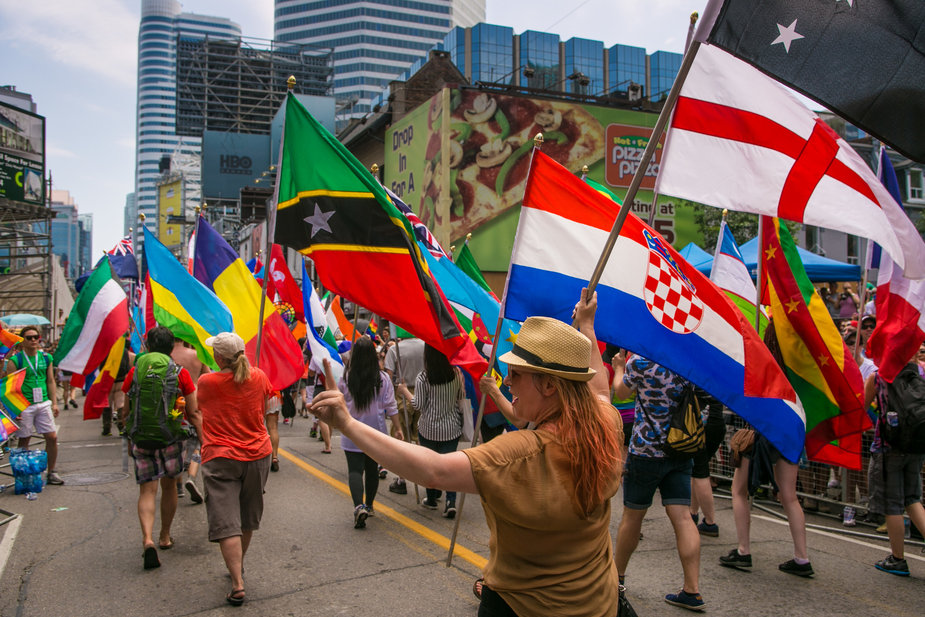 People carry international flags during World Pride in Toronto