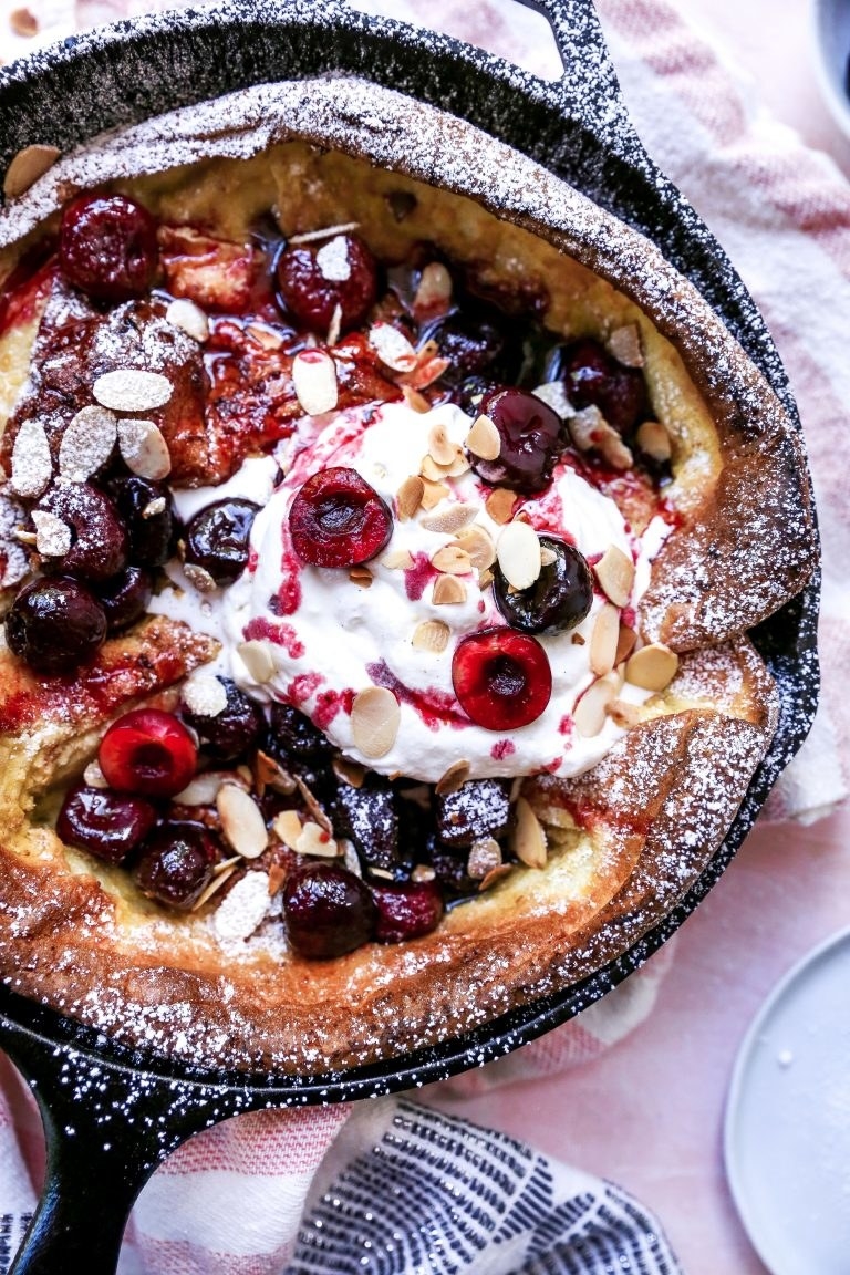 A Dutch baby pancake with cherries and almonds.