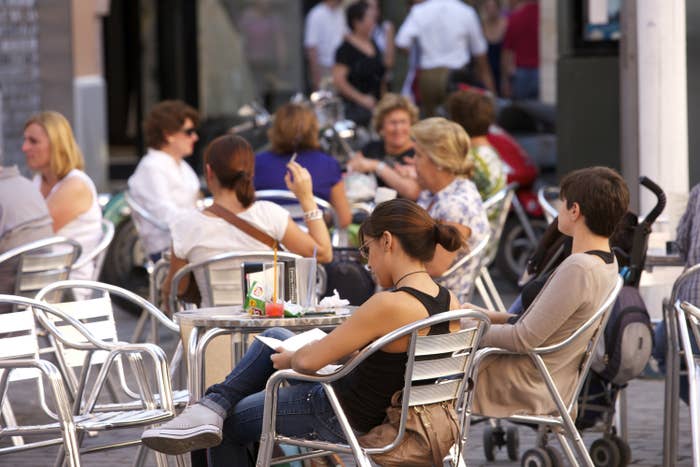 People sitting at a cafe in Seville, Spain