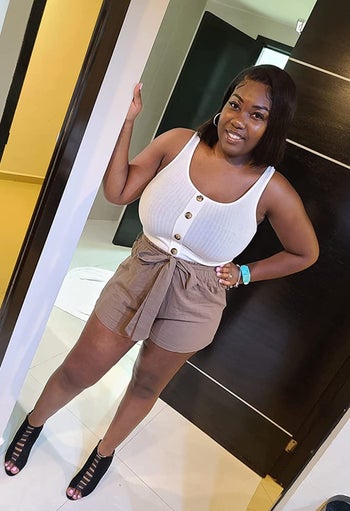 Reviewer wearing the white paisley romper