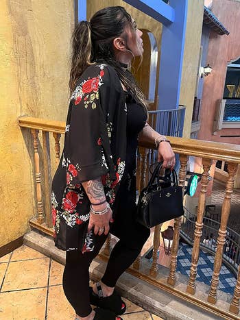 Reviewer wearing the black floral cardigan