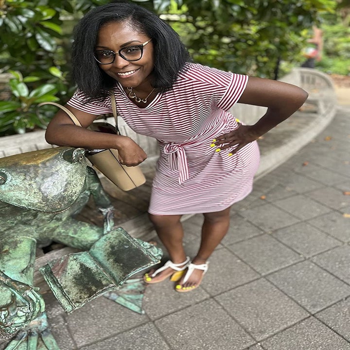 Reviewer wearing the pink and white dress