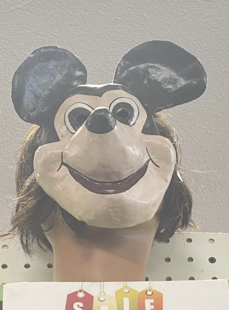 A plastic Mickey Mouse mask with hair
