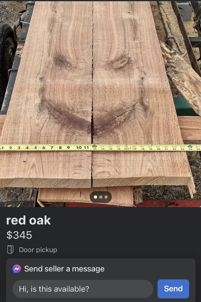 Two planks of red oak that seem to have a scary face on them selling for $345