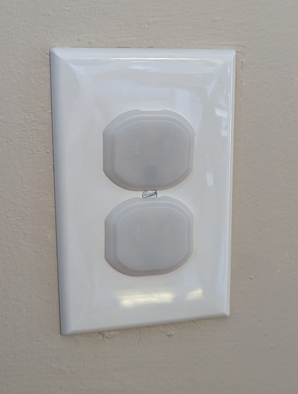 Reviewer&#x27;s photo of plastic plug protectors in outlet