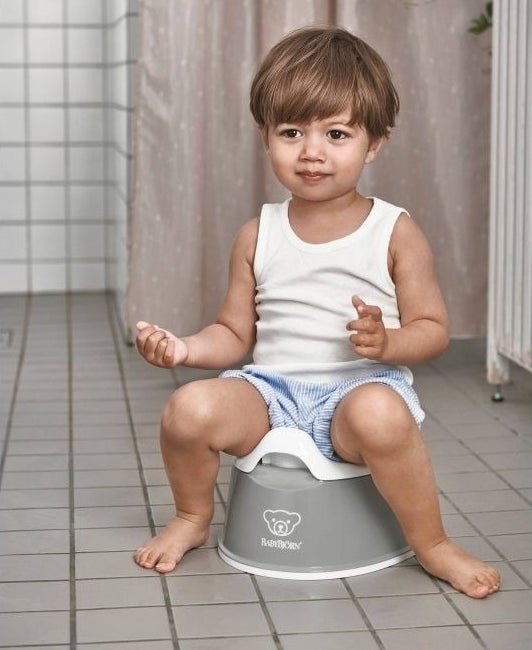 Child sits on a potty