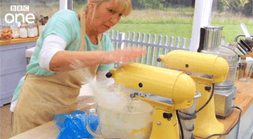 A woman making a mess with a mixer
