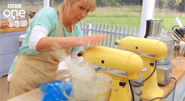 A woman making a mess with a mixer