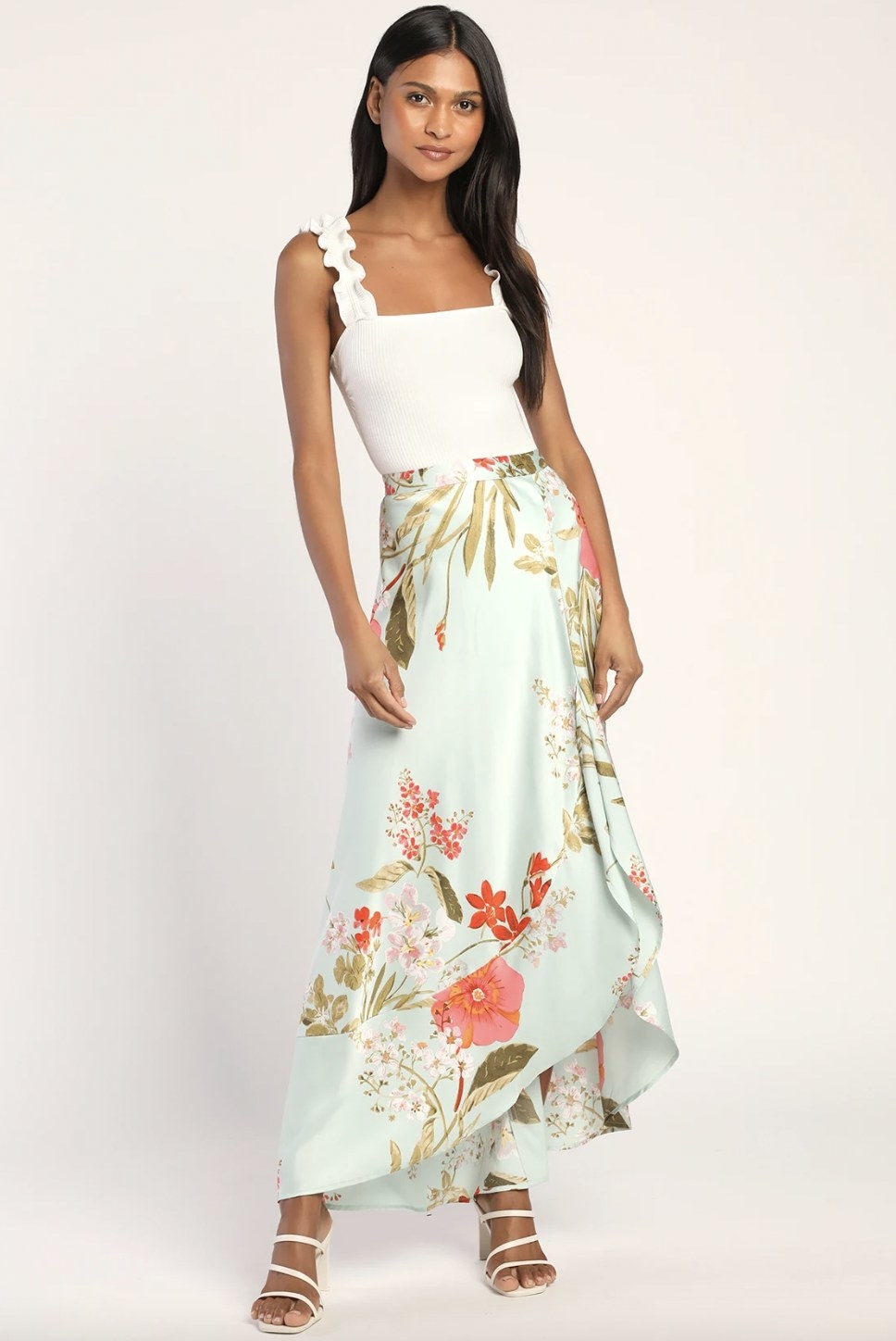 A model wearing a mint colored maxi skirt with floral details