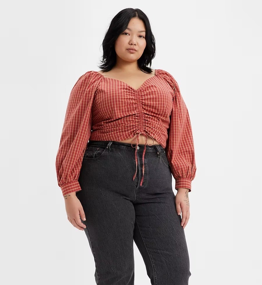 A model in the red plaid top