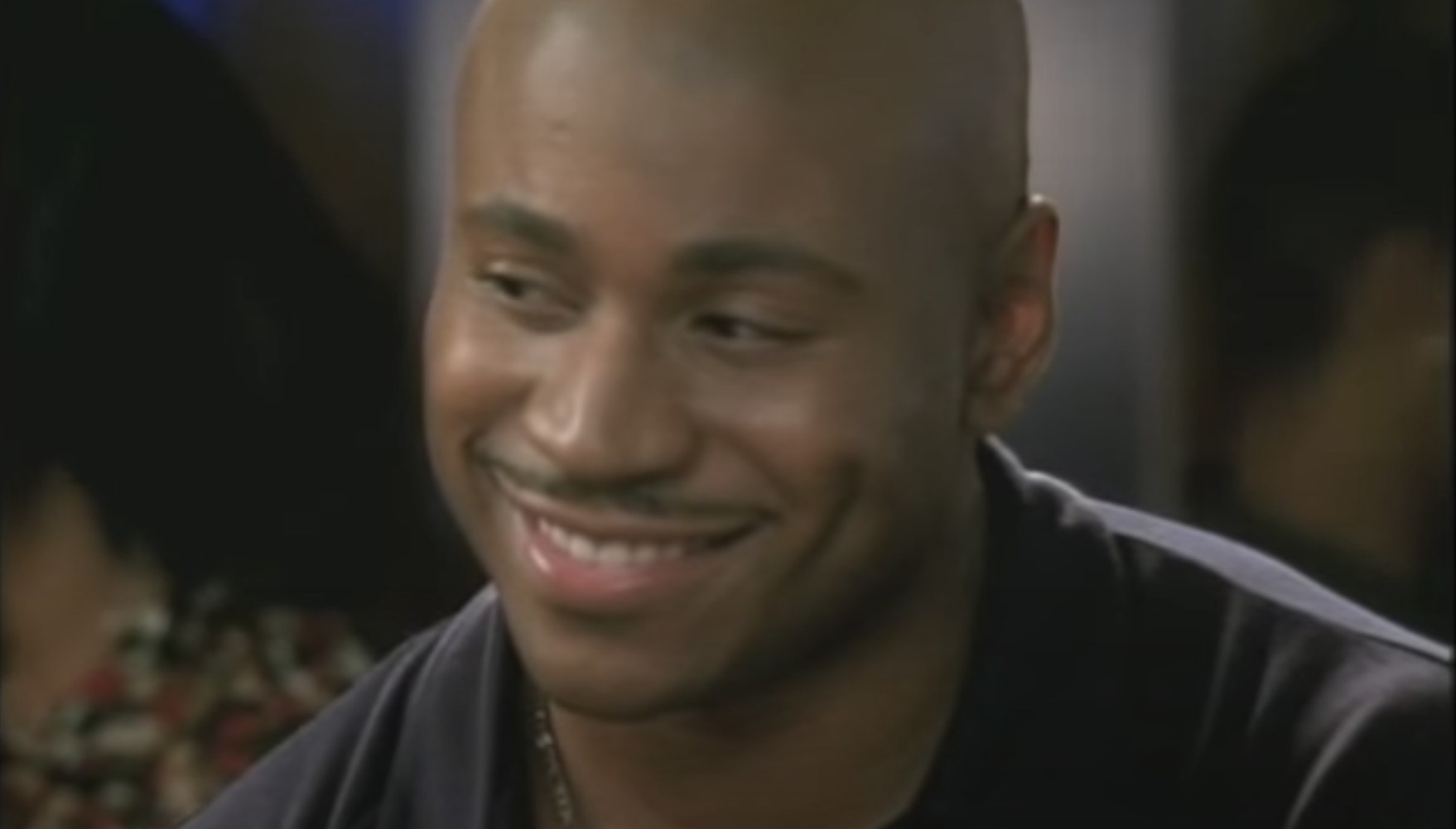 LL Cool Jay smiling and looking off to the side during a scene from "Deliver Us From Eva."