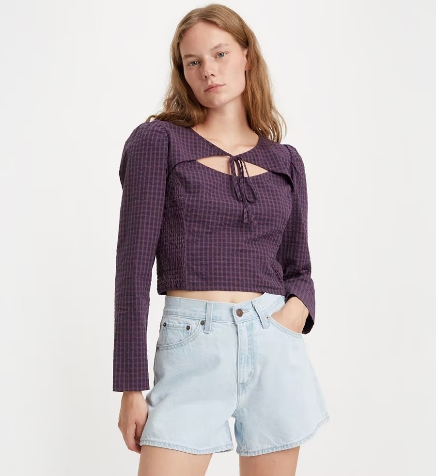 A model in the purple long sleeve top