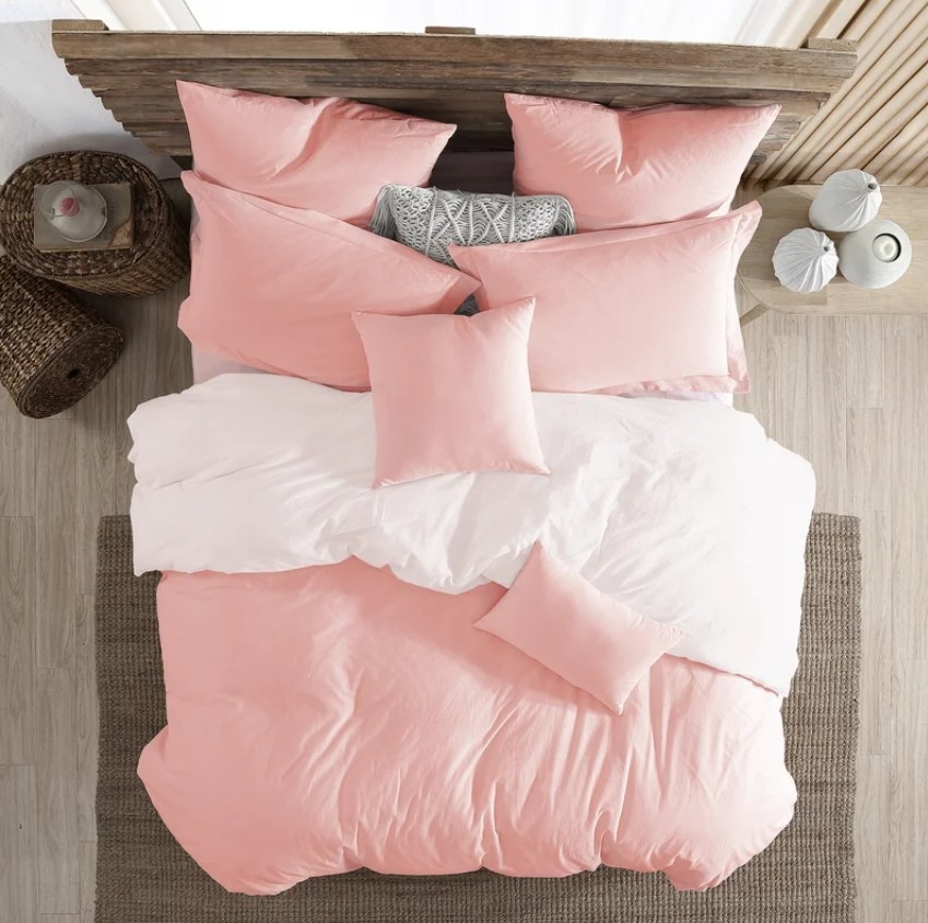 The pink duvet cover and sham set on a bed shown from birdseye view