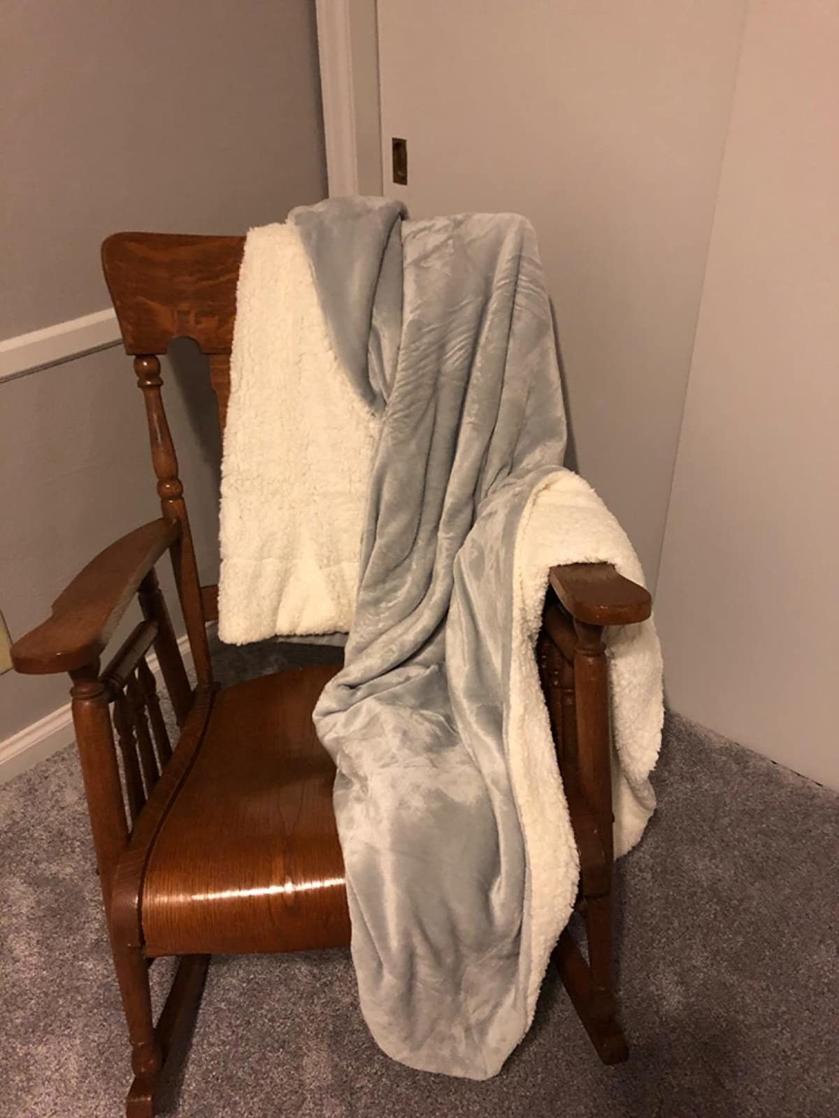 Reviewer image of the gray blanket on a rocking chair