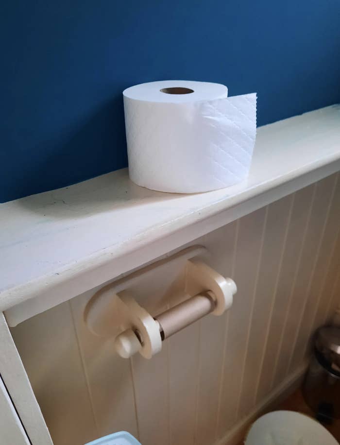 Toilet paper above an empty roll