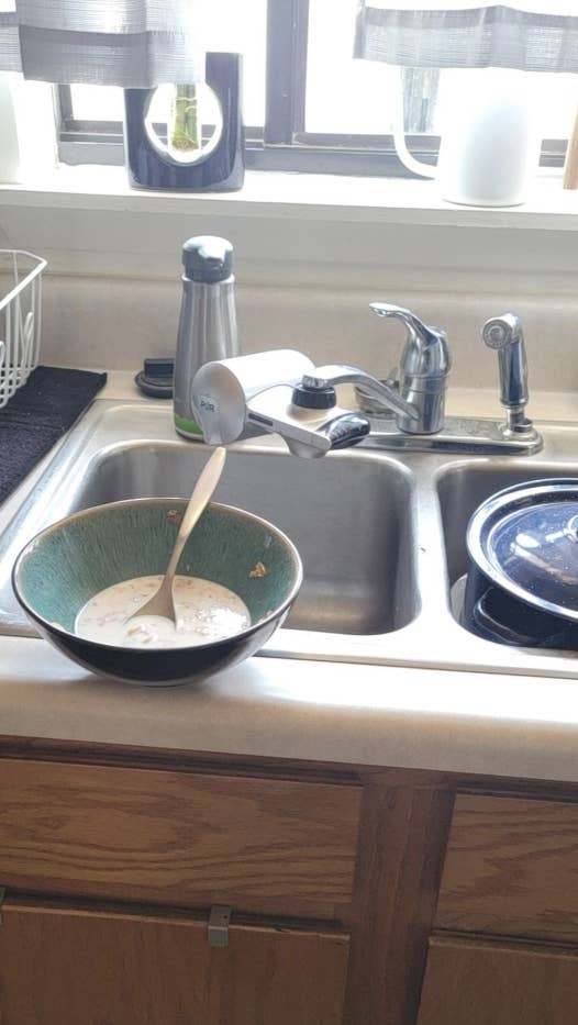 A bowl on the edge of the sink