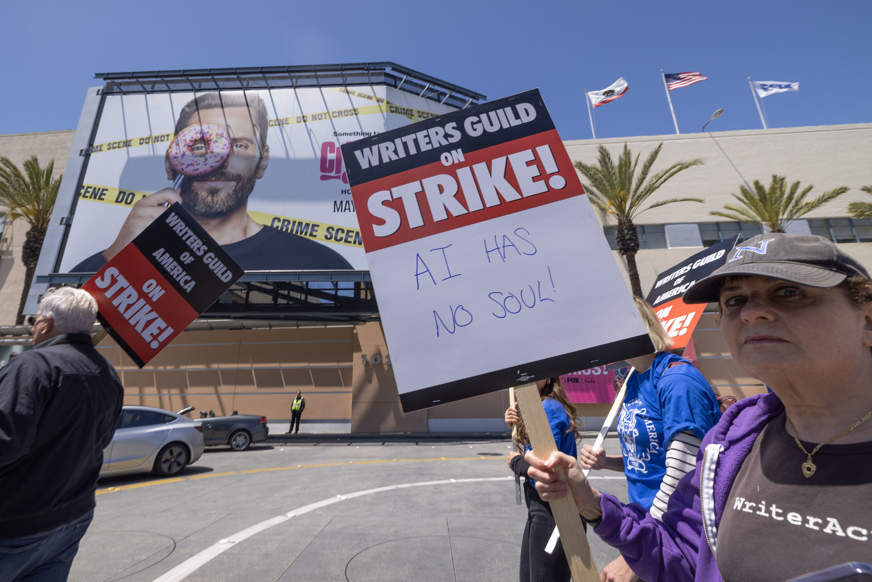 A WGA supporter holds a sign that says, &quot;AI has no soul&quot;