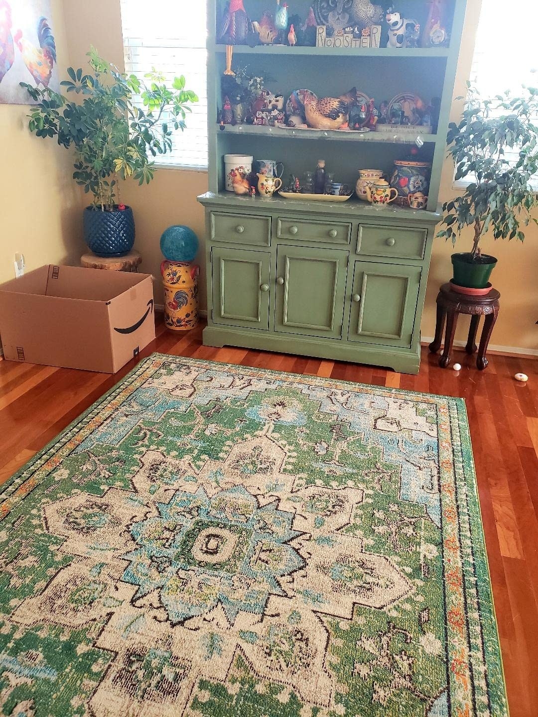 Reviewer image of the blue, green, and cream area rug