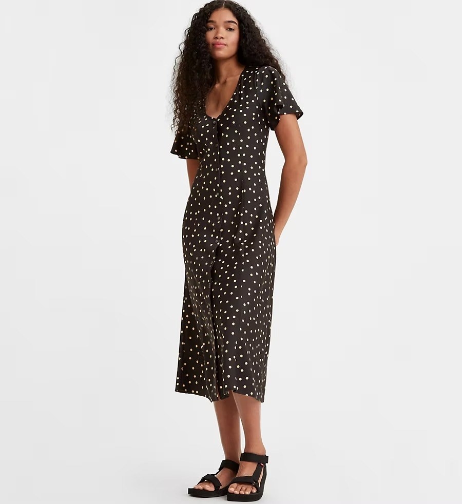 A model in the flower printed black midi dress