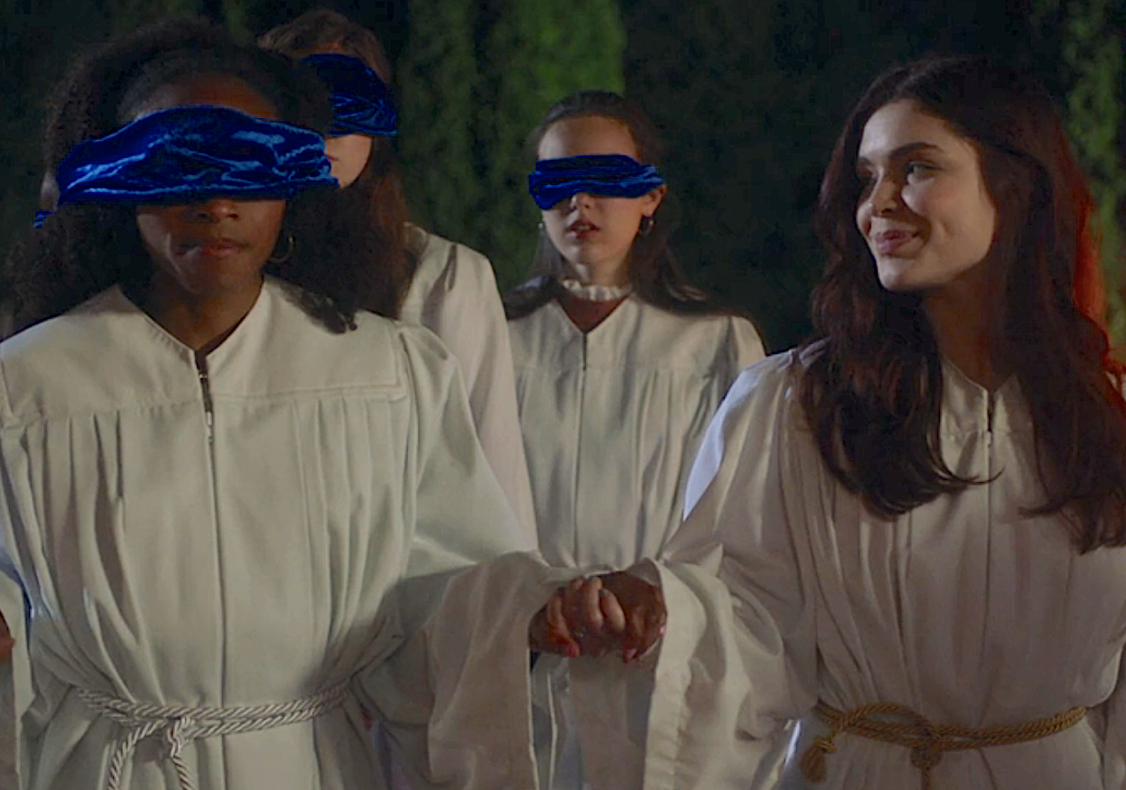 Sorority pledges wearing blindfolds