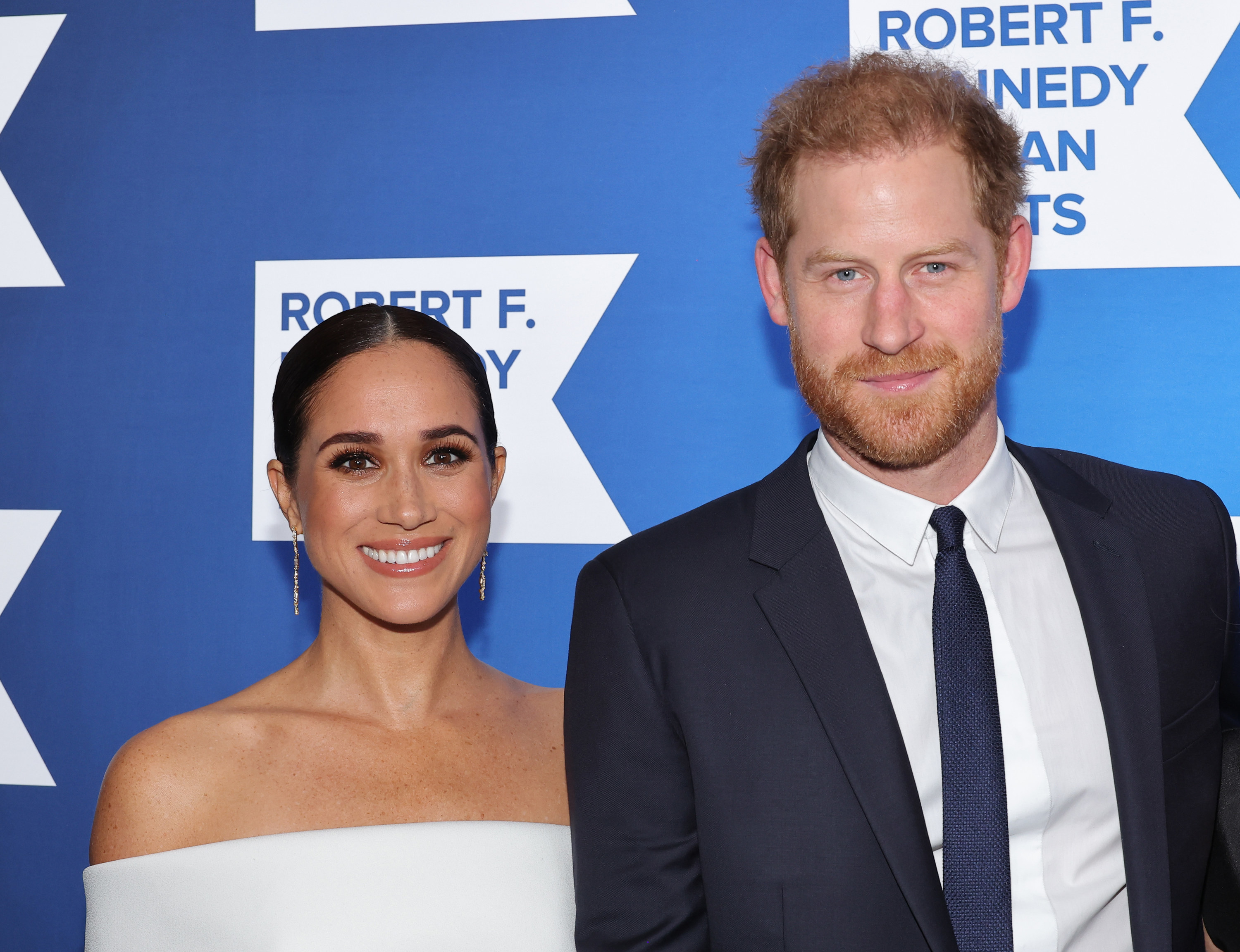 A closeup of meghan and harry at a red carpet event