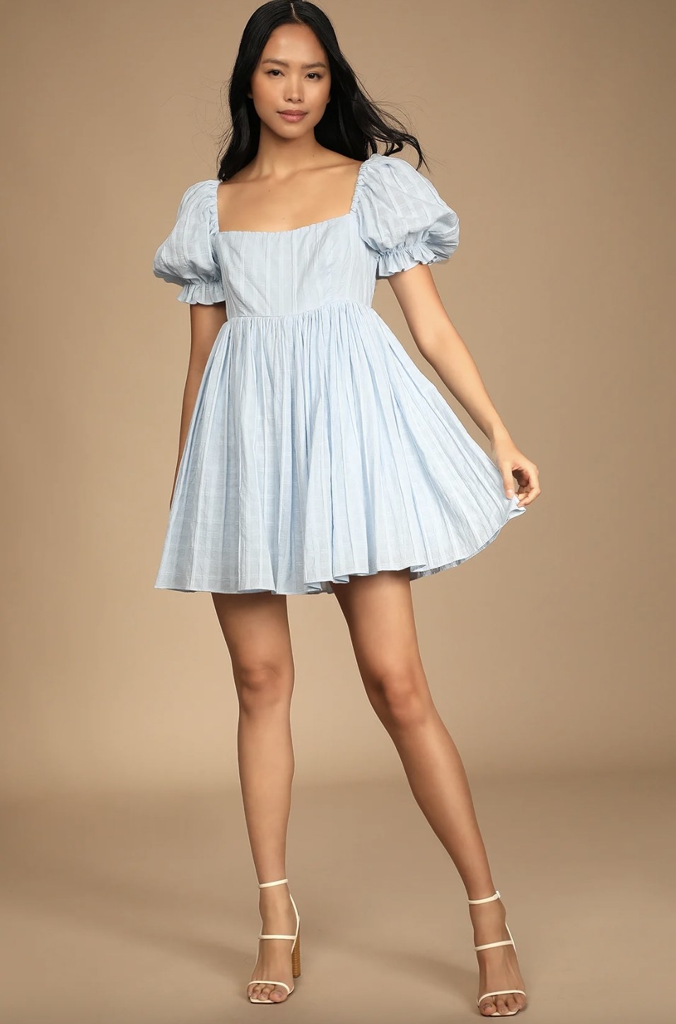 a model wearing the dress in light blue