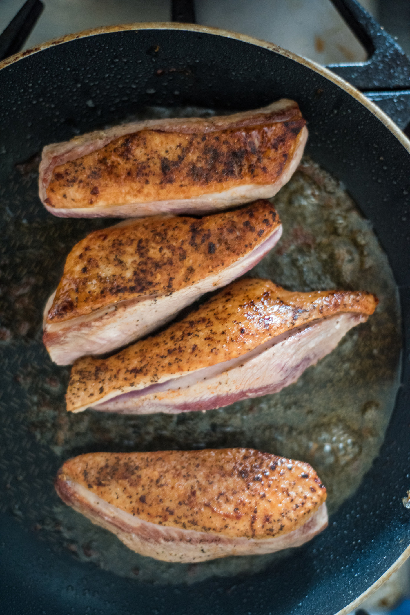 Cooking duck breast in a pan.