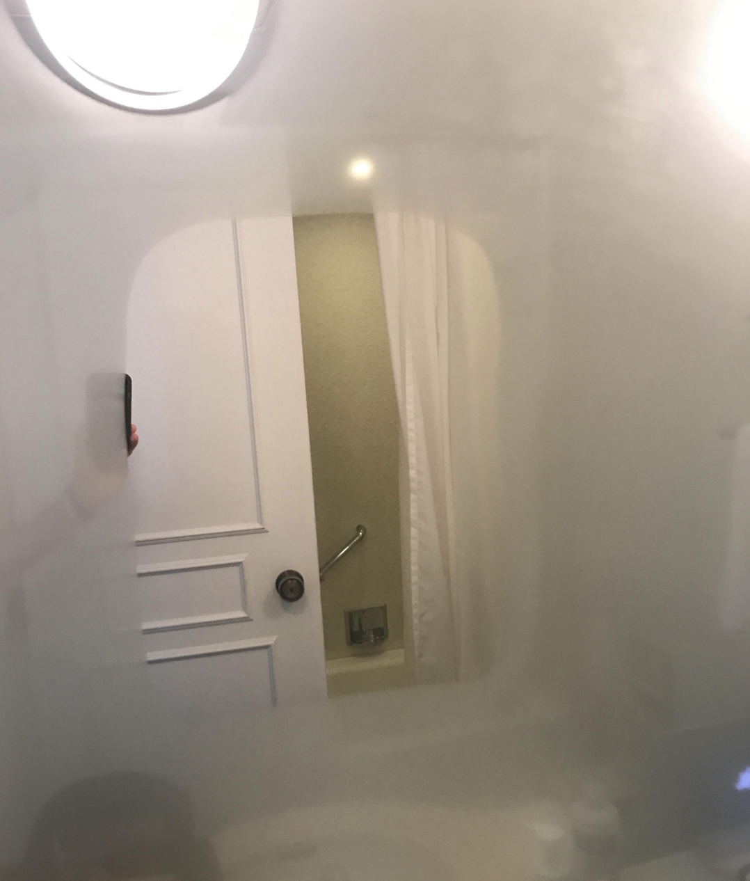 A bathroom with a heated mirror
