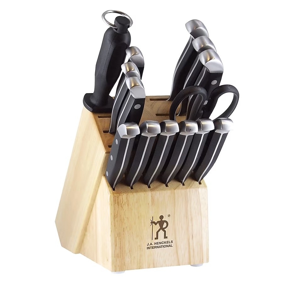A brown knife block with black and silver knives