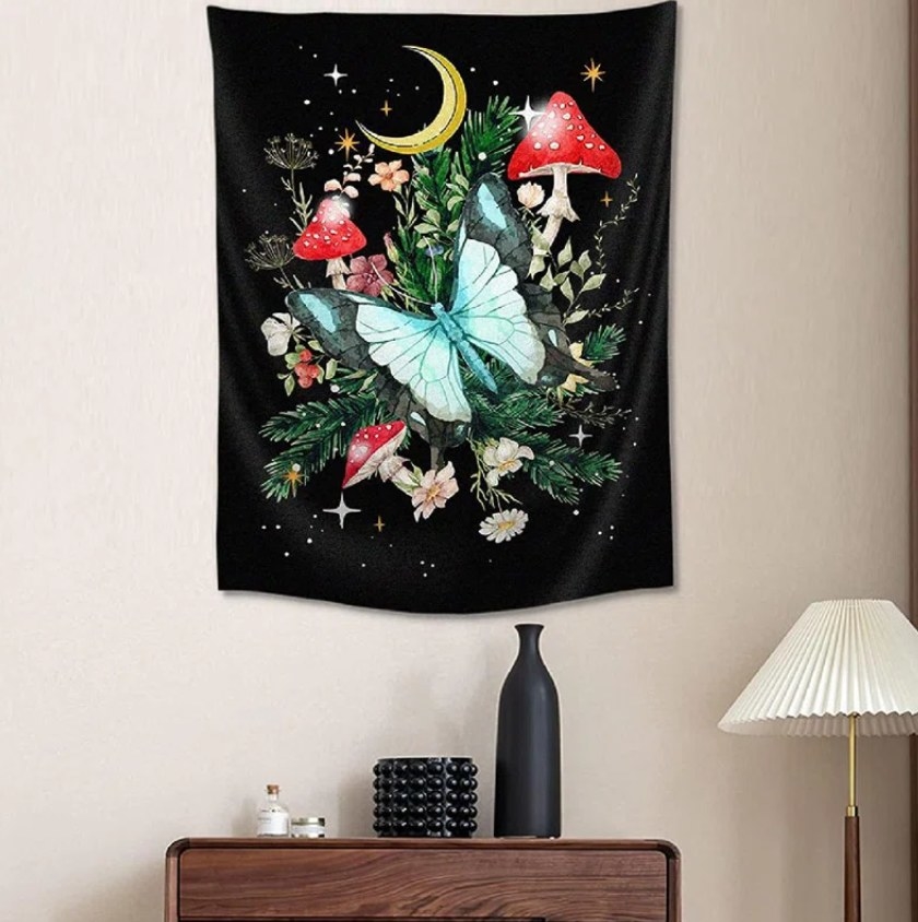 The mushroom and butterfly tapestry hung on the wall