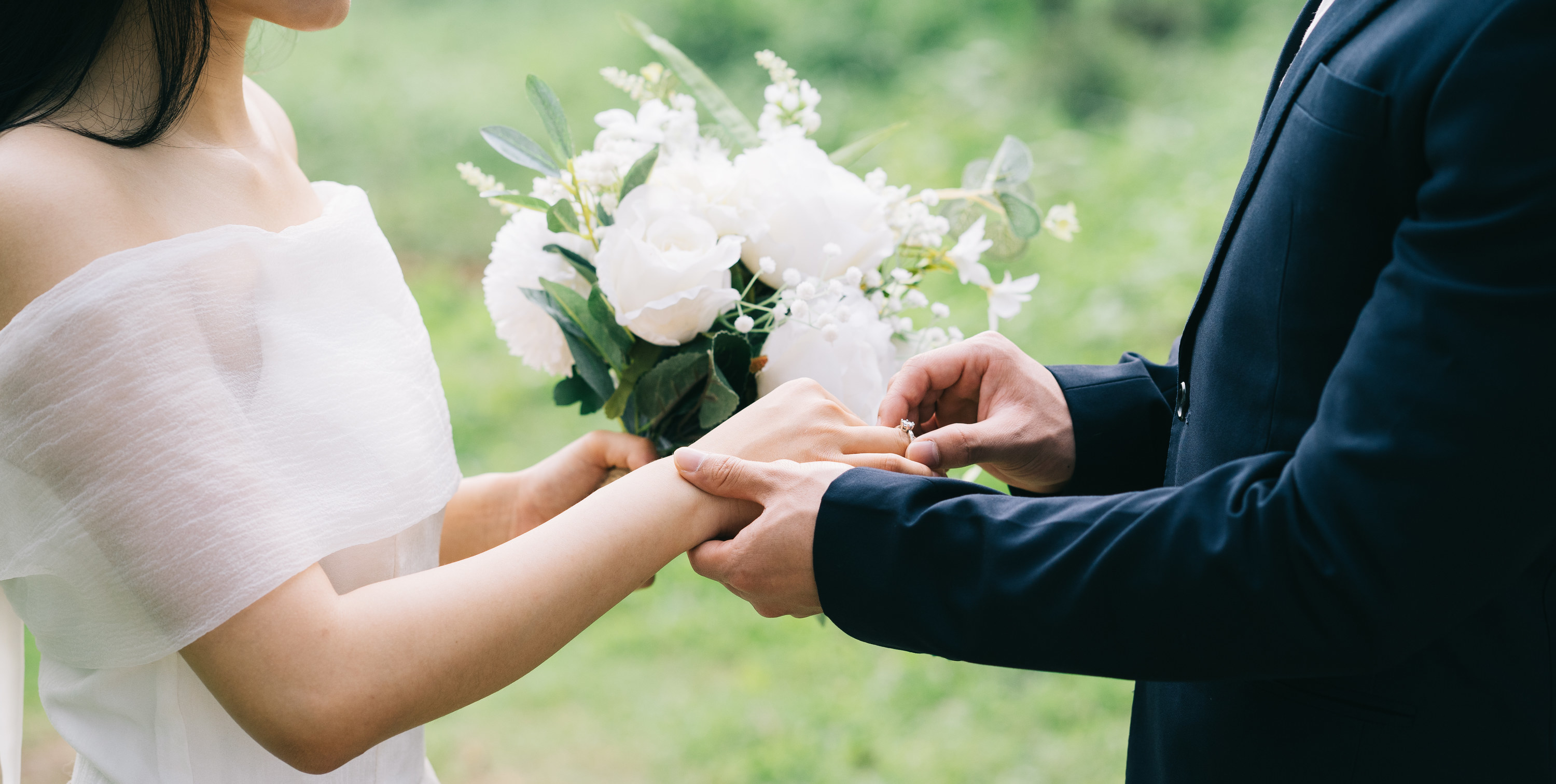 a couple holding hands on their wedding day