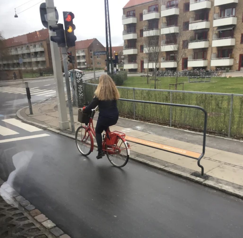 A rail for people on bicycles to lean on