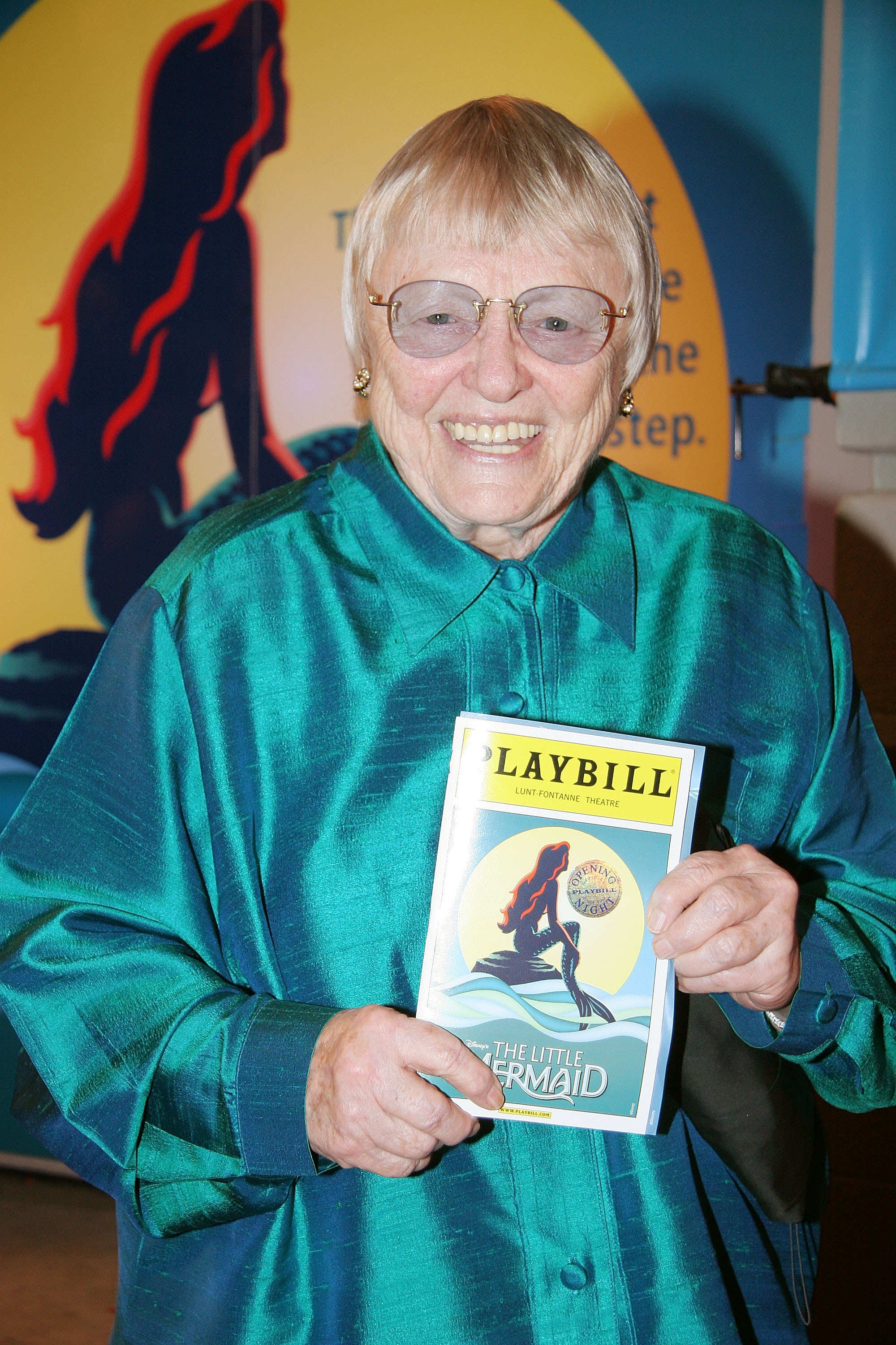 Pat Carroll holding a Playbill for The Little Mermaid theater play