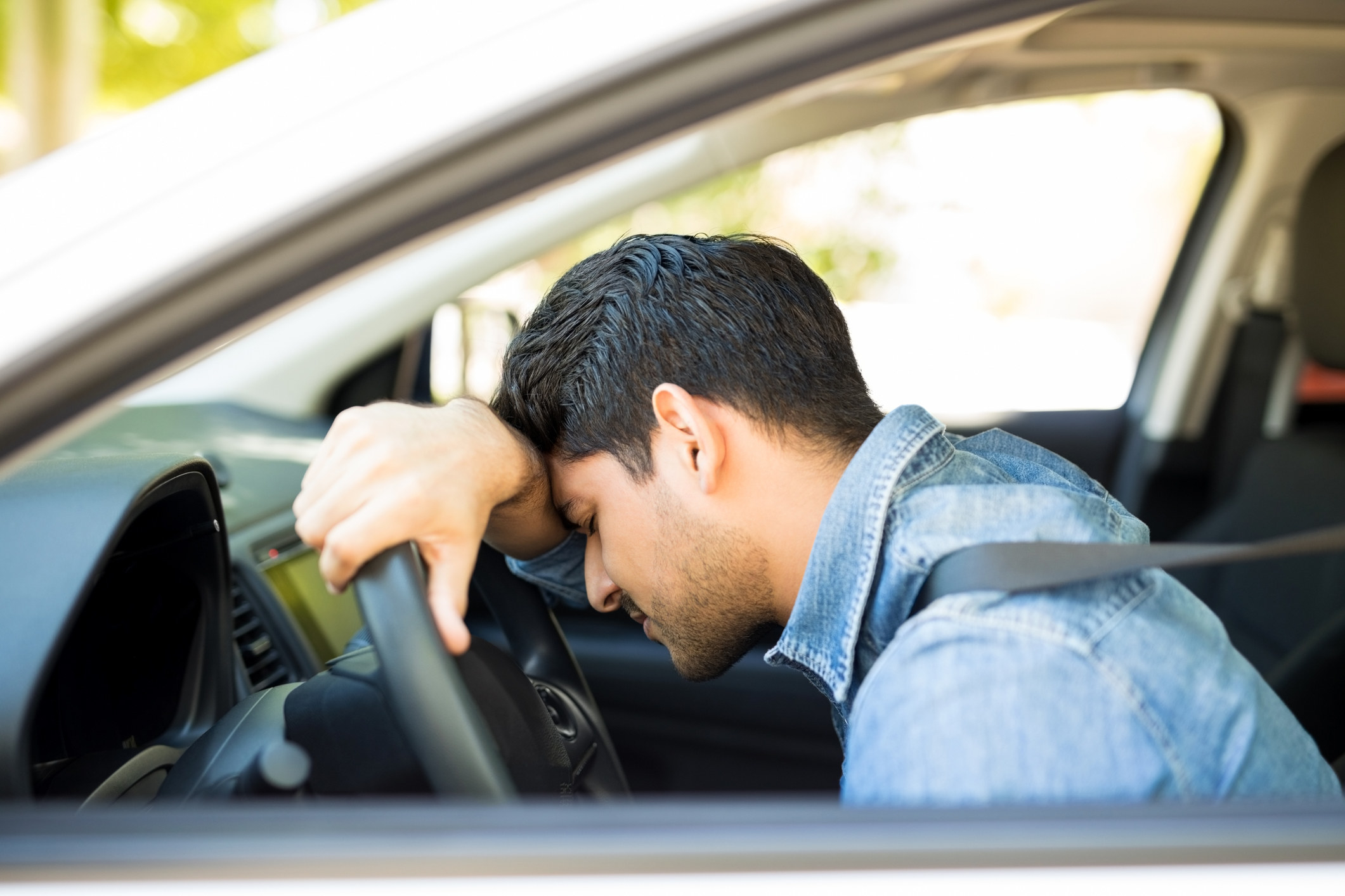 A man looking drained in his car