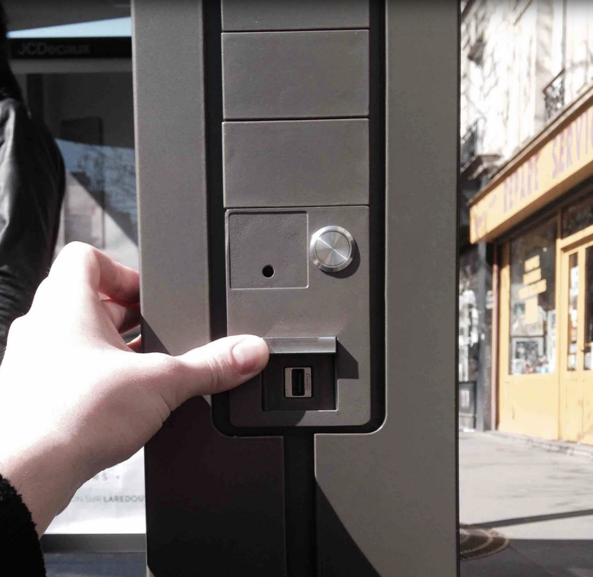 A phone charger at the bus stop