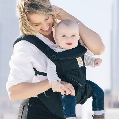 Parent carries a baby in a carrier
