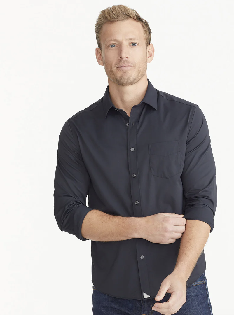 A man wearing a black unwrinkled Untuckit button-up shirt