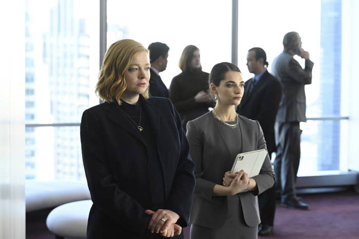 Sarah Snook standing next to another woman in the office in a scene from succession