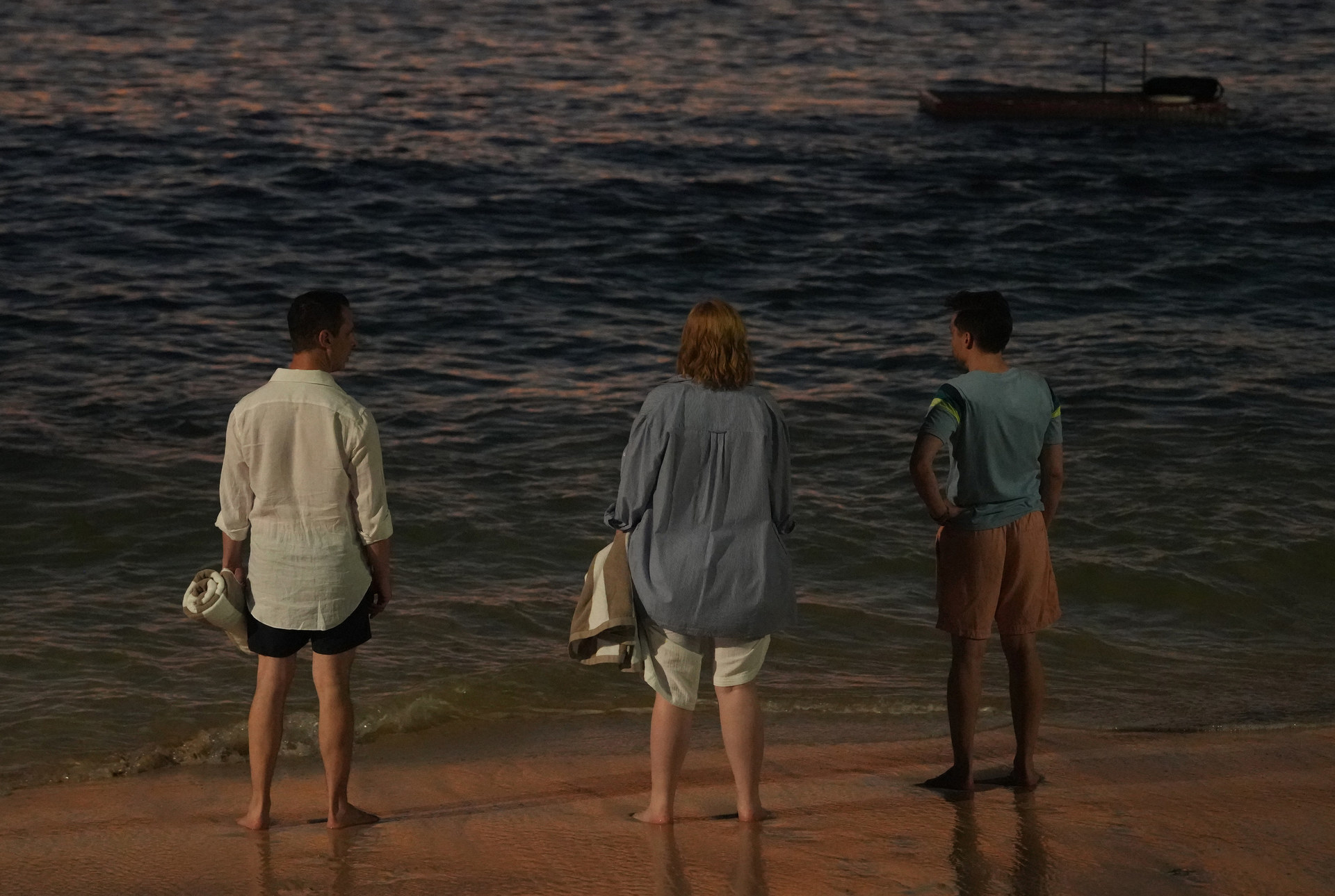 jeremy strong, sarah snook, and kieran culkin standing on a beach in a scene from succession