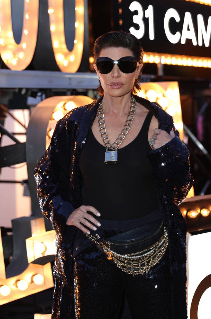 A closeup of Lisa Rinna wearing sunglasses and a sequined coat