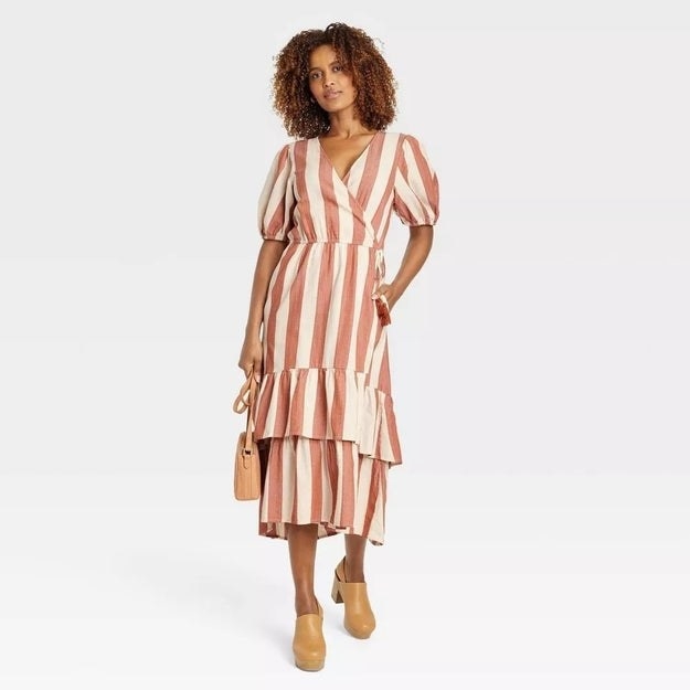 A model in the vertical striped dress with a tiered skirt