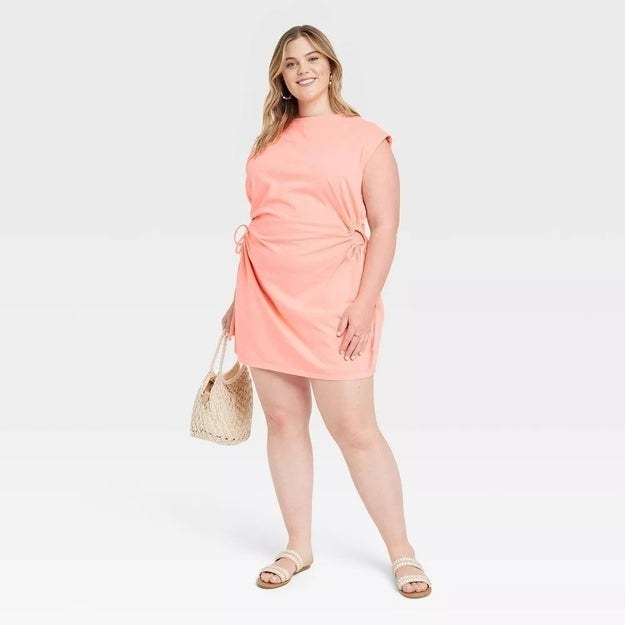 A model in the pastel coral mini dress