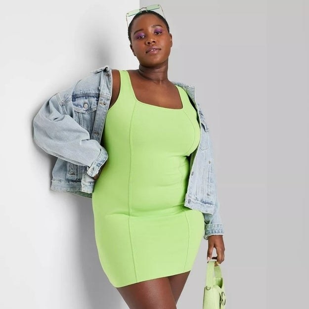 A model in the highlighter green bodycon dressA model in the white and blue striped midi dress