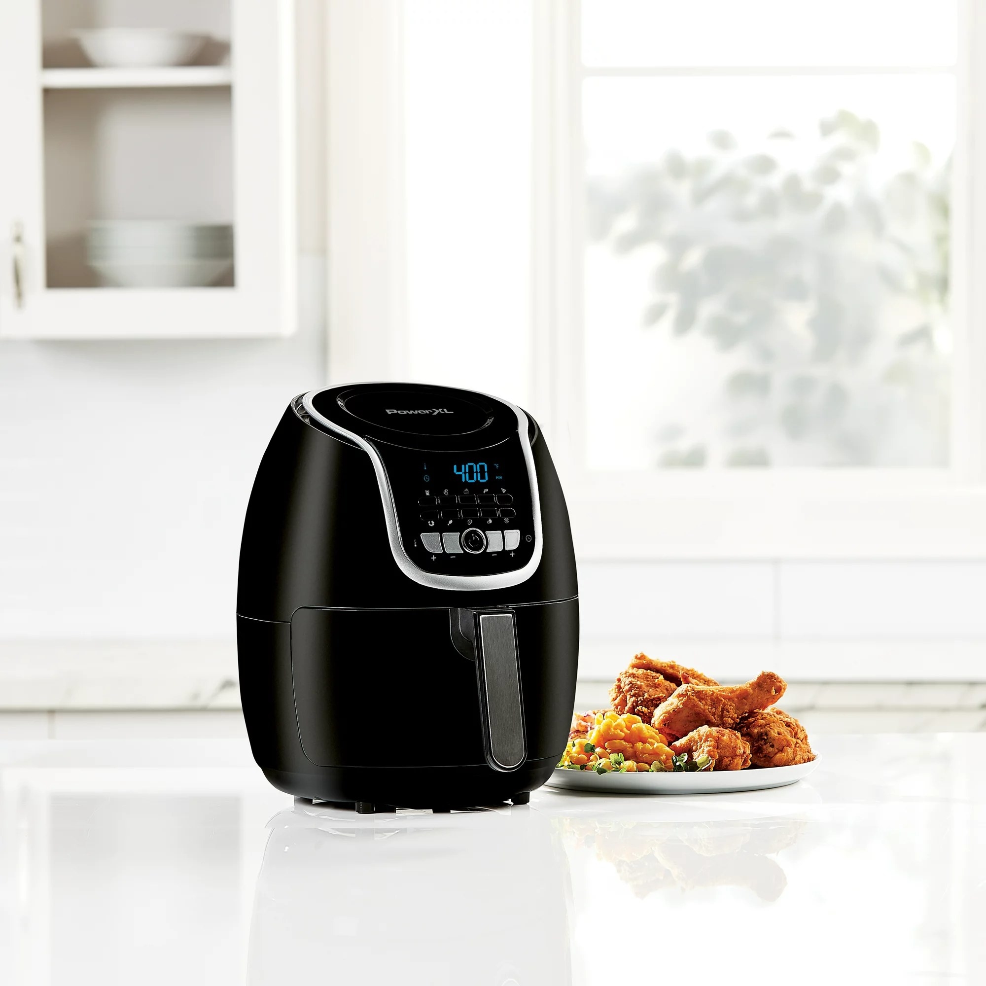 the air fryer with a plate of food next to it