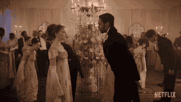 A man bows to a woman