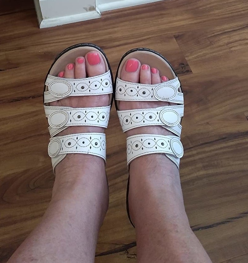 A reviewer wearing white sandals